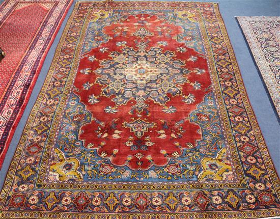 A Kashan red ground carpet, 12ft 9in by 6ft 7in.